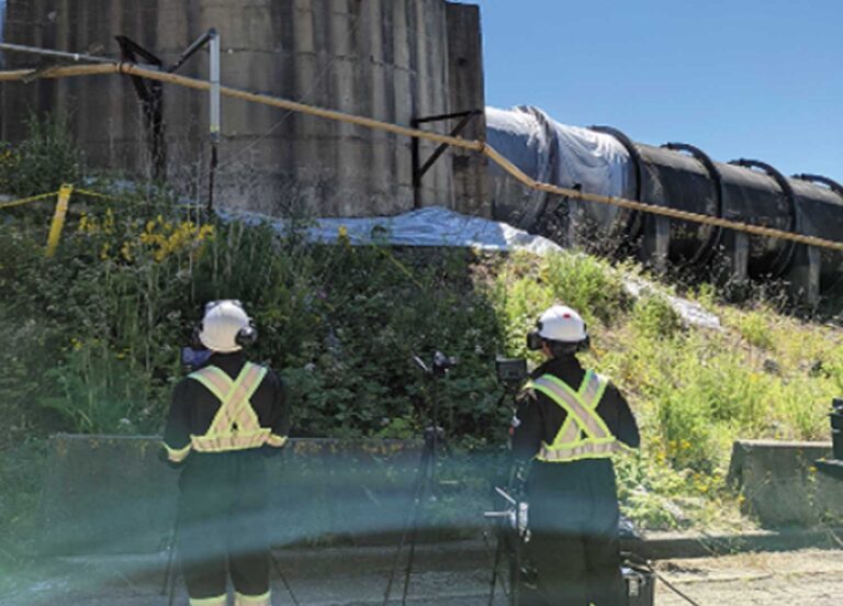 SKYRON performing ultrasonic thickness testing on tank shell in hazardous environment. Inspection team